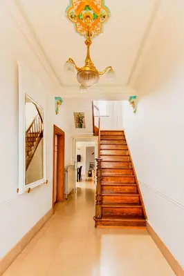 a staircase in a home with a chandelier at Beautiful mansion with swimming pool and jacuzzi in Bilzen