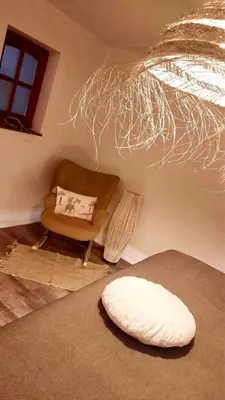 a living room with a couch and a chair at Au coeur du 11 in Beyne-Heusay