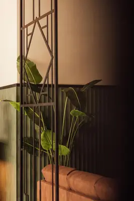 a plant in a vase next to a mirror at Getaway Liège in Liège