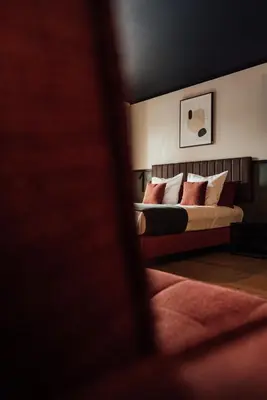 a bedroom with a bed with red and white pillows at Getaway Liège in Liège