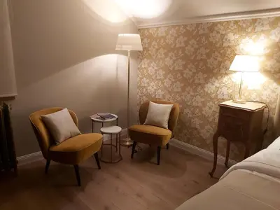 a room with two chairs and a bed and a table at B&B Asmara in Maasmechelen
