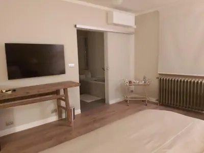 a living room with a flat screen tv on a wall at B&B Asmara in Maasmechelen