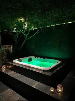 a bath tub with green water in a dark room at Suite Marie in Verviers
