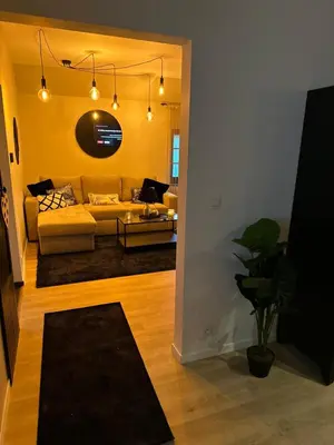 a living room with a couch and a table at Suite Marie in Verviers