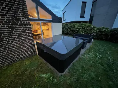 a hot tub in the backyard of a house at Le Gîte du Moulin - Modernity & Elegance - jacuzzi in Oupeye