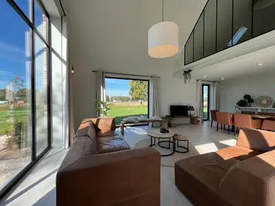a living room with a couch and a table at Huis Hygge in Peer