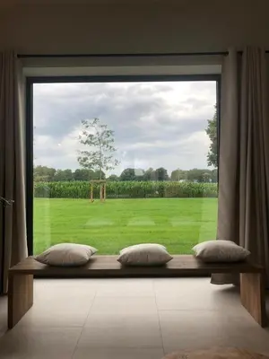 a large window with a view of a field at Huis Hygge in Peer