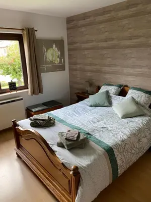 a bedroom with a bed with two towels on it at Le Logis du Plateau in Herve