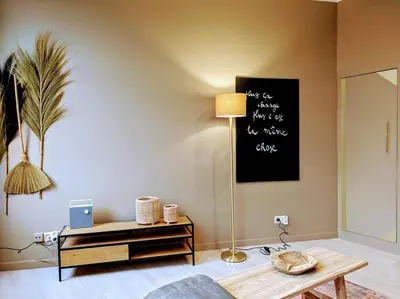 a living room with a table and a blackboard on the wall at La Tour by WelcHome in Verviers
