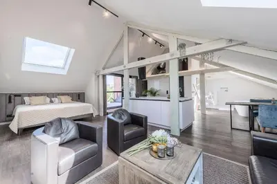 a living room with a bed and a couch and a table at Hof van In & Wellness in Hasselt