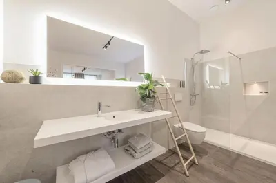a bathroom with a sink and a toilet and a mirror at Hof van In & Wellness in Hasselt