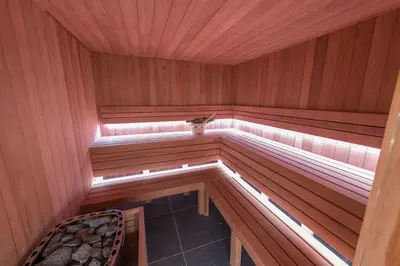 an inside of a sauna with a chair in it at Hof van In & Wellness in Hasselt