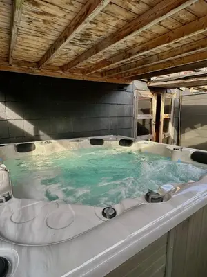 a large bath tub with blue water in it at Cosy@Beauty in Petit-Rechain