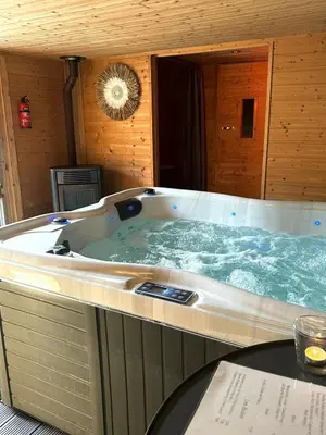 a large jacuzzi tub in a wooden room at Cosy@Beauty in Petit-Rechain
