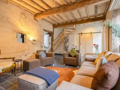 a living room with couches and chairs at Maison Cuberdon in Riemst