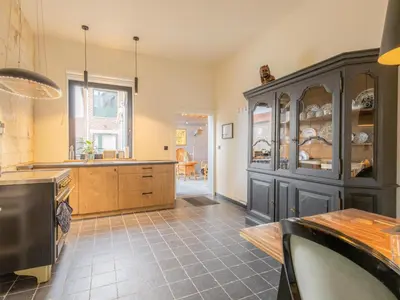 a large kitchen with a large blue cabinet at Maison Cuberdon in Riemst