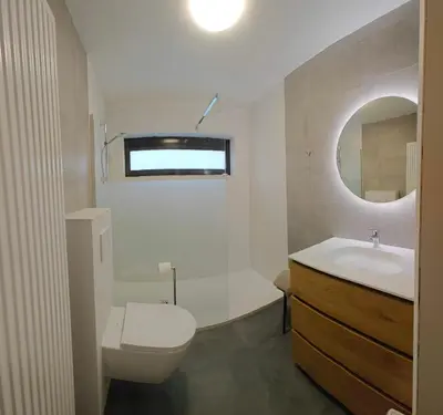 a bathroom with a sink and a toilet and a mirror at Brelaarheide in Houthalen-Helchteren