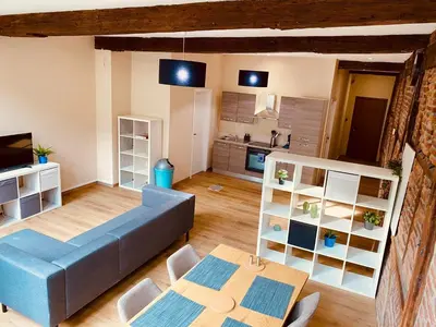 a living room with a blue couch and a table at The Mind Box 2 in Liège
