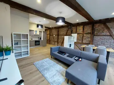 a living room with a blue couch and a table at The Mind Box 2 in Liège