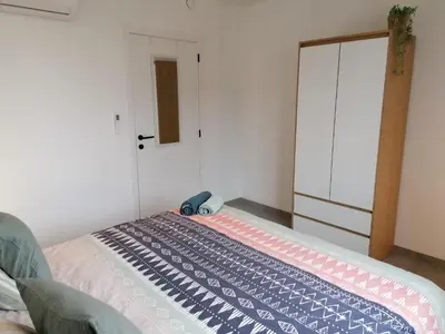 a small bedroom with a bed with auggage at Rent & Relax: Vitrabelle in Lommel