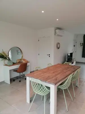 a dining room with a wooden table and chairs at Rent & Relax: Vitrabelle in Lommel