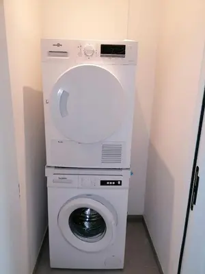 a white washer and dryer in a small room at Rent & Relax: Vitrabelle in Lommel