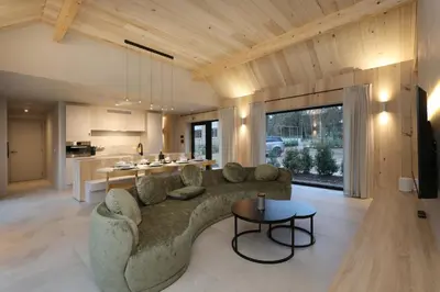 a living room with a couch and a table at Woodz Lodges in Heusden - Zolder