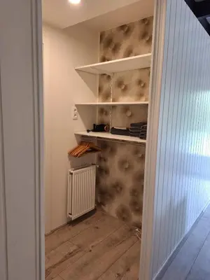 a walk in pantry with a wall covered in wallpaper at Vrijstaande vakantiebungalow met optimale privacy!! in Rekem