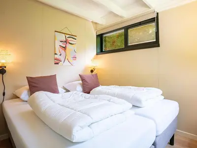 two white beds in a room with a window at Boshuisje Rekem - Alma with private sauna in Lanaken