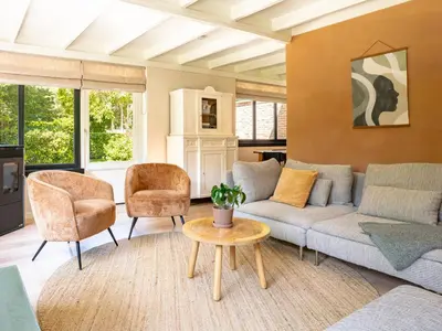 a living room with a couch and chairs and a table at Boshuisje Rekem - Alma with private sauna in Lanaken