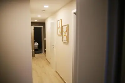 a hallway with a hallway leading to a bathroom at L'appart Baobab, avec sauna in Liège