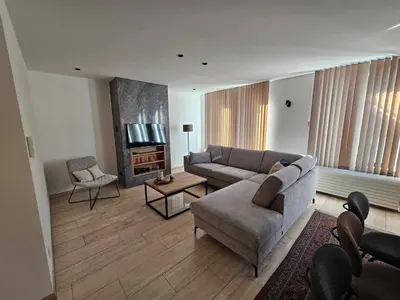 a living room with a couch and a tv at Stadsparel Sint-Truiden in Sint-Truiden