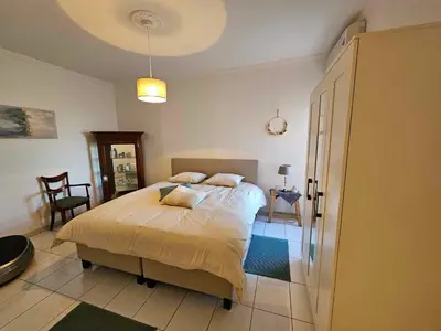 a bedroom with a bed and a table and chairs at Stadsparel Sint-Truiden in Sint-Truiden