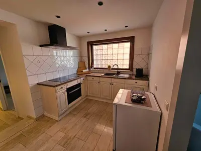 a kitchen with a sink and a stove top oven at Stadsparel Sint-Truiden in Sint-Truiden