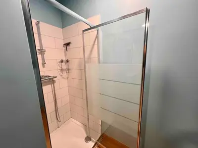 a shower with a glass door in a bathroom at Le rétro chic - Grand Duplex pour 6 dans le centre in Liège