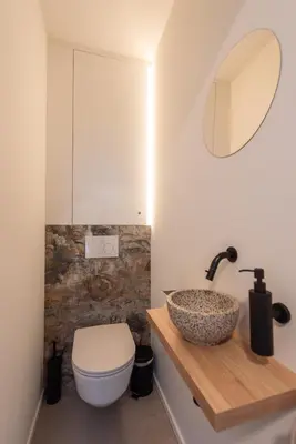 a bathroom with a toilet and a sink at NIEUW - De Grenspaal OOST 7P - 3SLPK - SAUNA - LAADPAAL in Riemst
