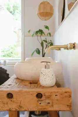 a bathroom with a table with a sink and a lamp at Superbe appartement avec cheminée in Verviers