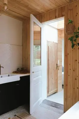an open door to a kitchen with a sink at Superbe appartement avec cheminée in Verviers
