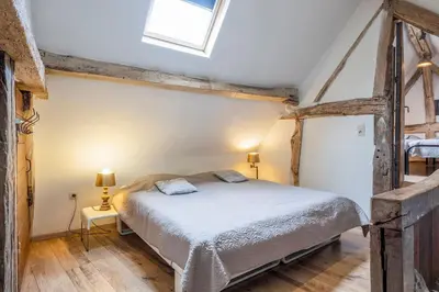a bedroom with a bed and a skylight at Authentic apartment in Voeren in Voeren