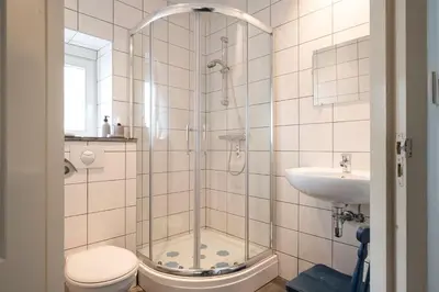 a bathroom with a shower and a toilet and a sink at Authentic apartment in Voeren in Voeren
