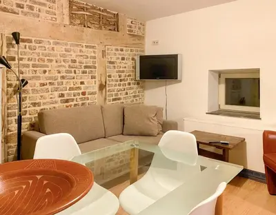 a living room with a couch and a glass table at Beautiful appartment in Voeren in Voeren