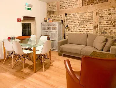 a living room with a table and chairs and a couch at Beautiful appartment in Voeren in Voeren