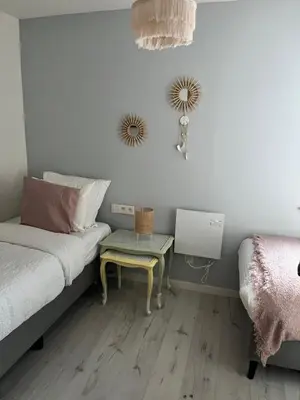 a bedroom with a bed with a table on it at De Koer Kanne - bij Maastricht in Kanne