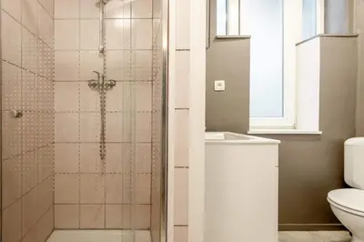 a bathroom with a shower with a toilet and a sink at Le Quai #7 - Calme et Confort près de Liège in Liège