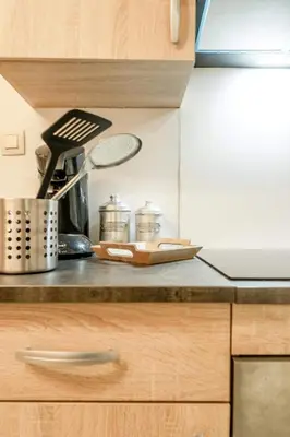 a kitchen counter with a coffee maker and utensils at Le Quai #7 - Calme et Confort près de Liège in Liège