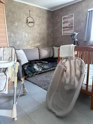 a living room with a couch and a bath tub at Studio Les Champs in Baelen