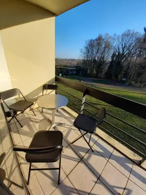 four chairs and a table on a balcony with a view at Ap22 Nature Ardennes Economy class apartment in La Calamine
