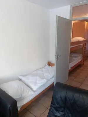 a room with a bed and a open door at Ap22 Nature Ardennes Economy class apartment in La Calamine