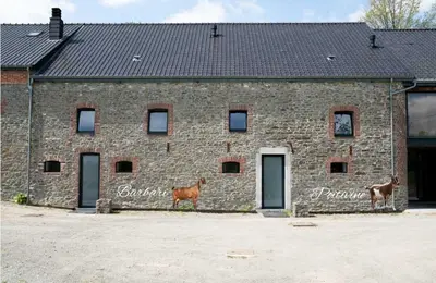 a brick building with two animals standing in front of it at Vakantiewoningen Hoeve Carpe Diem - Dalhem - Aubel - Voeren in Dalhem