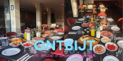 a long table with plates of food on it at Vakantiewoningen Hoeve Carpe Diem - Dalhem - Aubel - Voeren in Dalhem